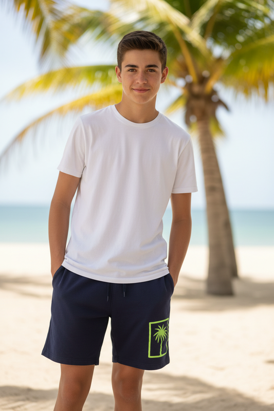 Boy wearing navy blue shorts with neon palm tree design